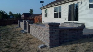 Spartan Landscaping LLC brick patio pavers with wall and arches